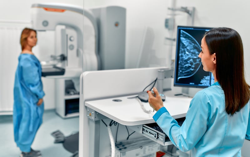 Specialist performing a mammography on female patient